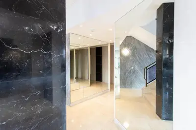 a hallway with black marble walls and a glass wall at C7 - 1 BDR Pointe Croisette 5min Sea - Parking, AC & Terrace in Cannes