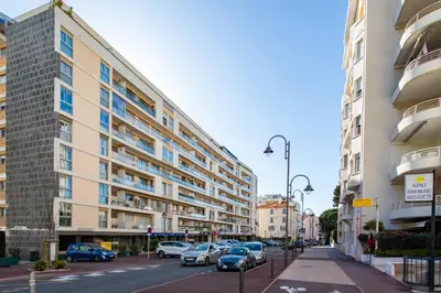 a street with cars parked in front of buildings at C7 - 1 BDR Pointe Croisette 5min Sea - Parking, AC & Terrace in Cannes
