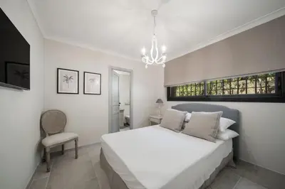 a bedroom with a white bed and a chandelier at REF 2135 - Cannes - Villa for rent in Cannes