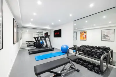 a gym with treadmills and machines in a room at REF 2135 - Cannes - Villa for rent in Cannes