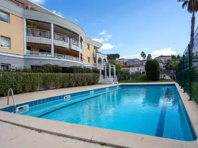 a swimming pool in front of a building at Apartment Les Cascades du Lac by Interhome in Le Cannet