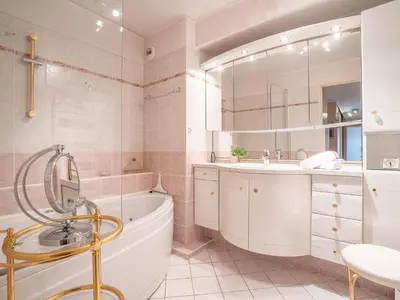 a bathroom with a tub and a sink at Apartment Les Cascades du Lac by Interhome in Le Cannet