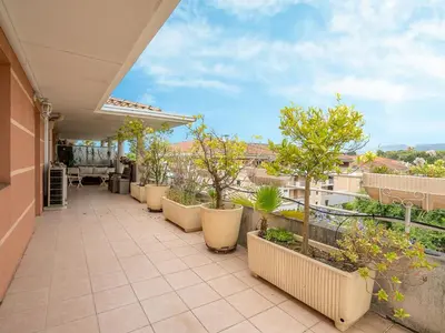 a balcony with plants and trees on a building at Apartment Les Cascades du Lac by Interhome in Le Cannet