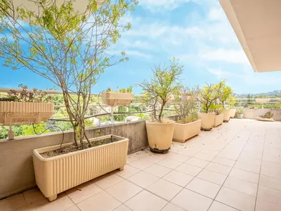 a row of potted trees on a balcony at Apartment Les Cascades du Lac by Interhome in Le Cannet