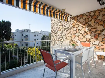 a patio with a table and chairs on a balcony at Apartment Val Joli-2 by Interhome in Cannes