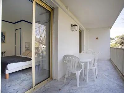 a room with a table and chairs and a bed at Apartment Val Joli-2 by Interhome in Cannes