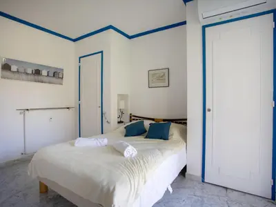 a bedroom with a bed with blue trim at Apartment Val Joli-2 by Interhome in Cannes