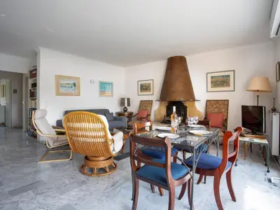 a living room with a table and chairs at Apartment Val Joli-2 by Interhome in Cannes