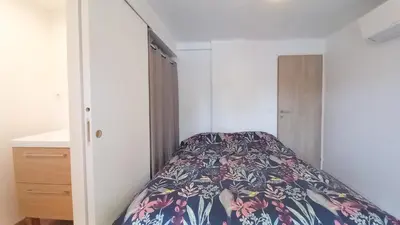 a bedroom with a bed with a floral bedspread at Maison moderne centre-ville in Cannes