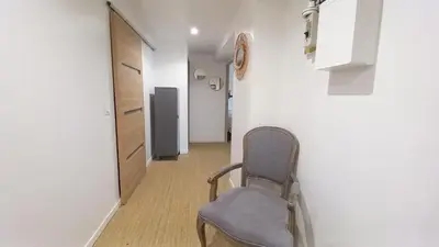 a chair sitting in a hallway with a room at Maison moderne centre-ville in Cannes