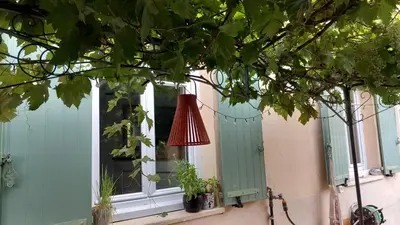 a window with green shutters and a red lamp at Maison moderne centre-ville in Cannes