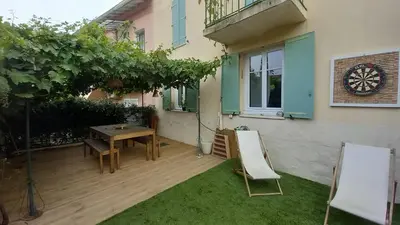 a patio with a table and chairs in front of a building at Maison moderne centre-ville in Cannes