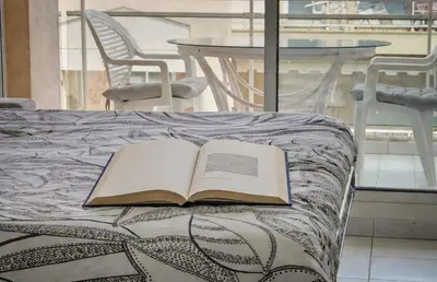 an open book sitting on top of a bed at FRGK Gallieni Terrace Quiet Executive Stay Walk to Palais in Cannes