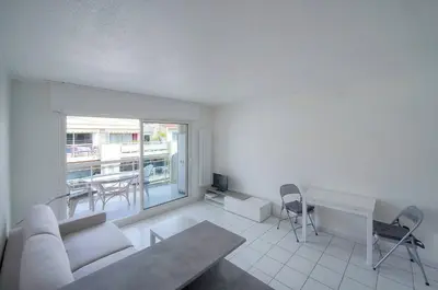 a living room with a couch and a table at FRGK Gallieni Terrace Quiet Executive Stay Walk to Palais in Cannes