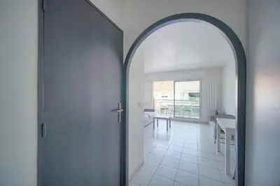 a kitchen with white cabinets and a table in it at FRGK Gallieni Terrace Quiet Executive Stay Walk to Palais in Cannes