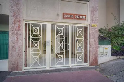 a glass door of a building with a sign on it at FRGK Gallieni Terrace Quiet Executive Stay Walk to Palais in Cannes