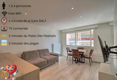 a living room with a couch and a table at Appartement plein centre proche Palais et plages in Cannes
