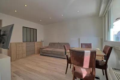a living room with a table and a couch at Appartement plein centre proche Palais et plages in Cannes