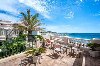 a balcony with chairs and a view of the ocean at Villa Palma near the beaches Cannes in Cannes