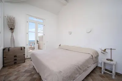 a white bedroom with a bed and a window at Villa Palma near the beaches Cannes in Cannes