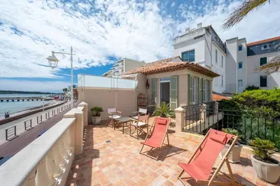 a balcony of a house with chairs and a table at Villa Palma near the beaches Cannes in Cannes