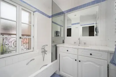 a white bathroom with a tub and a sink at Villa Palma near the beaches Cannes in Cannes