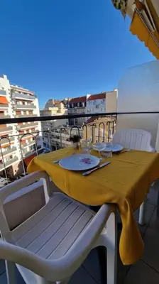 a table with a yellow table cloth on a balcony at Studio for 2 near the Croisette central with balcony 133 in Cannes