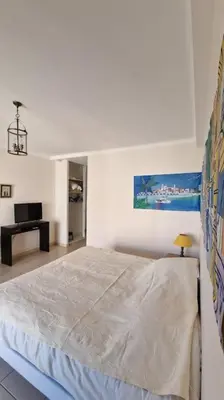 a bedroom with a large bed and a desk at Studio for 2 near the Croisette central with balcony 133 in Cannes