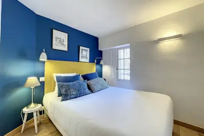 a bedroom with a large bed with blue walls at 1 Bedroom Ideal Location Cannes in Cannes