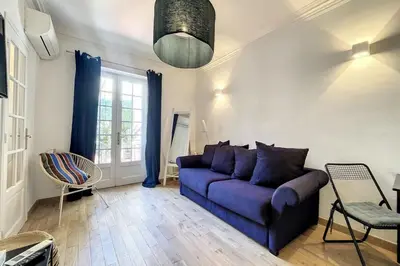 a living room with a purple couch and a window at 1 Bedroom Ideal Location Cannes in Cannes