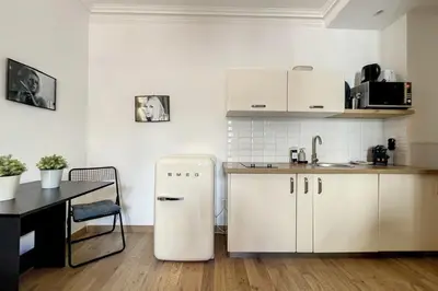 a kitchen with a white refrigerator and a table at 1 Bedroom Ideal Location Cannes in Cannes