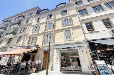 a large building on a street in front of a store at 1 Bedroom Ideal Location Cannes in Cannes
