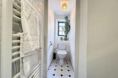 a white bathroom with a toilet in a hallway at 1 Bedroom Ideal Location Cannes in Cannes