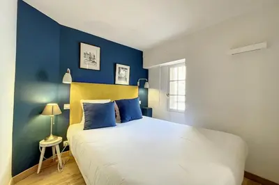 a bedroom with a large bed with blue walls at 1 Bedroom Ideal Location Cannes in Cannes