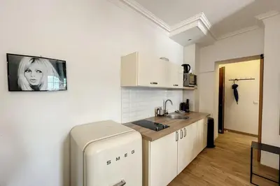 a small kitchen with a sink and a refrigerator at 1 Bedroom Ideal Location Cannes in Cannes