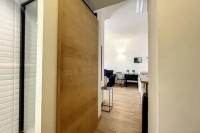 a hallway with a wooden door leading to a dining room at 1 Bedroom Ideal Location Cannes in Cannes