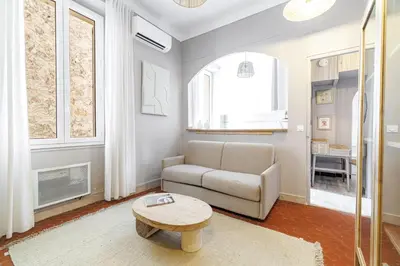 a living room with a couch and a table at L'Échappée Cannoise Forville in Cannes
