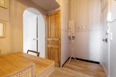 a room with a wooden table and a door at L'Échappée Cannoise Forville in Cannes