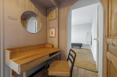 a room with a table and a mirror and a chair at L'Échappée Cannoise Forville in Cannes