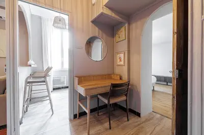 a dining room with a table and a mirror at L'Échappée Cannoise Forville in Cannes