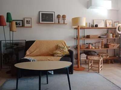 a living room with a couch and a table at STUDIO VILLA VIANNEY in Cannes