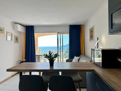 a dining room with a table and a view of the ocean at Villa FRANCIA bat Van Gogh in Cannes