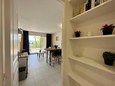 a hallway with a kitchen and a dining room at Villa FRANCIA bat Van Gogh in Cannes