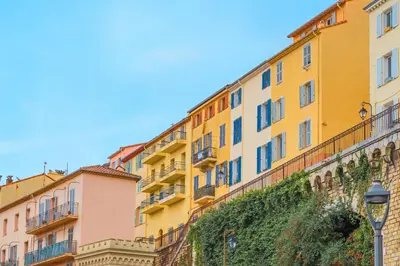 a row of colourful buildings on a street at 5mn Palais des festivals - Vue sur le Port - BS in Cannes