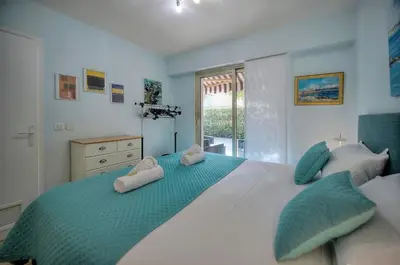 a bedroom with a large bed with two pillows at Immogroom - Quiet T2 - Garden level - AC - Wifi in Cannes