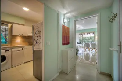 a kitchen with a door leading to a dining room at Immogroom - Quiet T2 - Garden level - AC - Wifi in Cannes