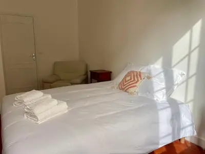 a white bed with towels on it with a chair at Le Zeus - Cannes Villa St Henri seafront unique 2bedrooms in Cannes