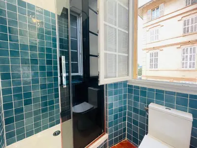 a bathroom with a toilet and a window at Le Zeus - Cannes Villa St Henri seafront unique 2bedrooms in Cannes