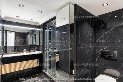 a bathroom with a sink and a mirror at Cannes appart 3 chambres luxe - Impératrice in Cannes