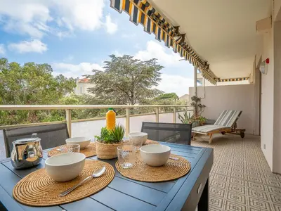 a blue table with bowls and plates on a balcony at Apartment Les Aliscamps by Interhome in Cannes